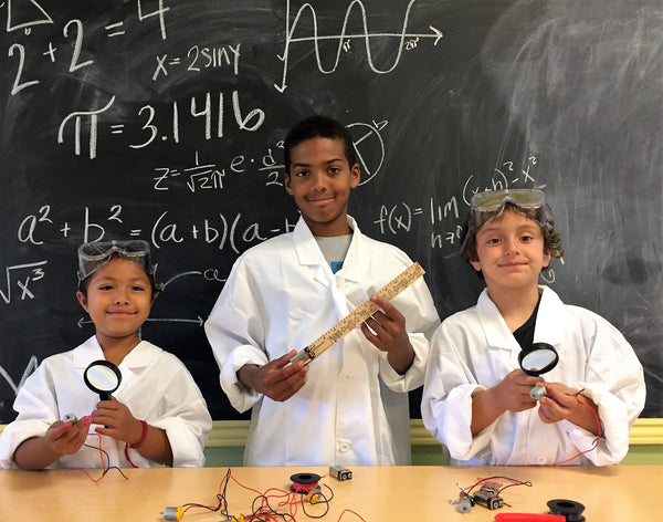 child in front of chalkboard