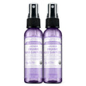 Two bottles of Dr. Bronners Lavender Organic Hand Sanitizer stand upright on a white background. Each bottle reads Family Soapmakers Since 1858. Lavender Organic Hand Sanitizer. Certified Fair Trade Ingredients. 2 FL OZ 59mL